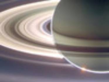 Saturn shelters the sun, creating a view that illuminates planet and its rings